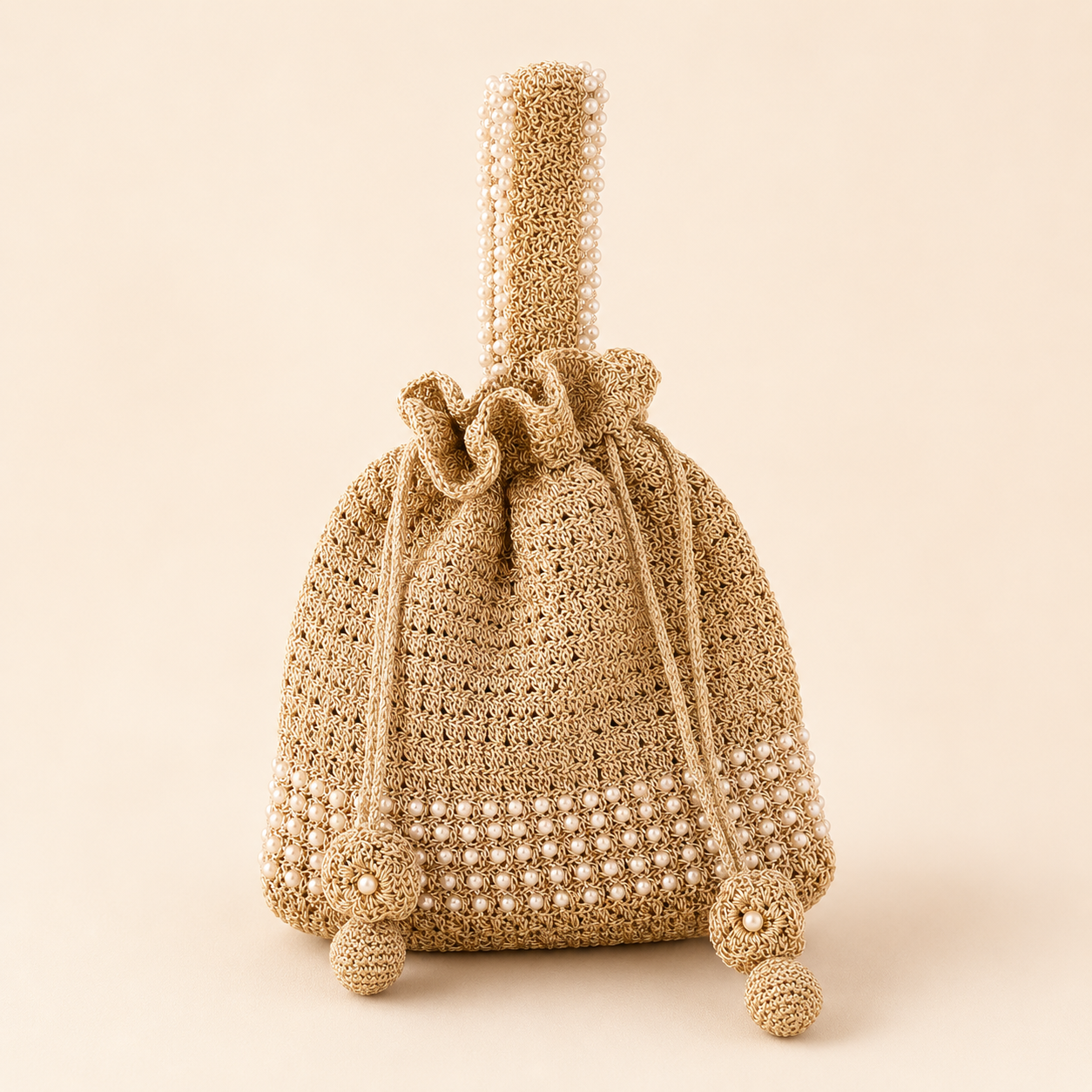 Front view of pearl-trimmed gold zari wristlet potli